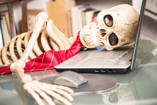 skeleton-businessman-worked-to-death-in-office-picture-id903491394